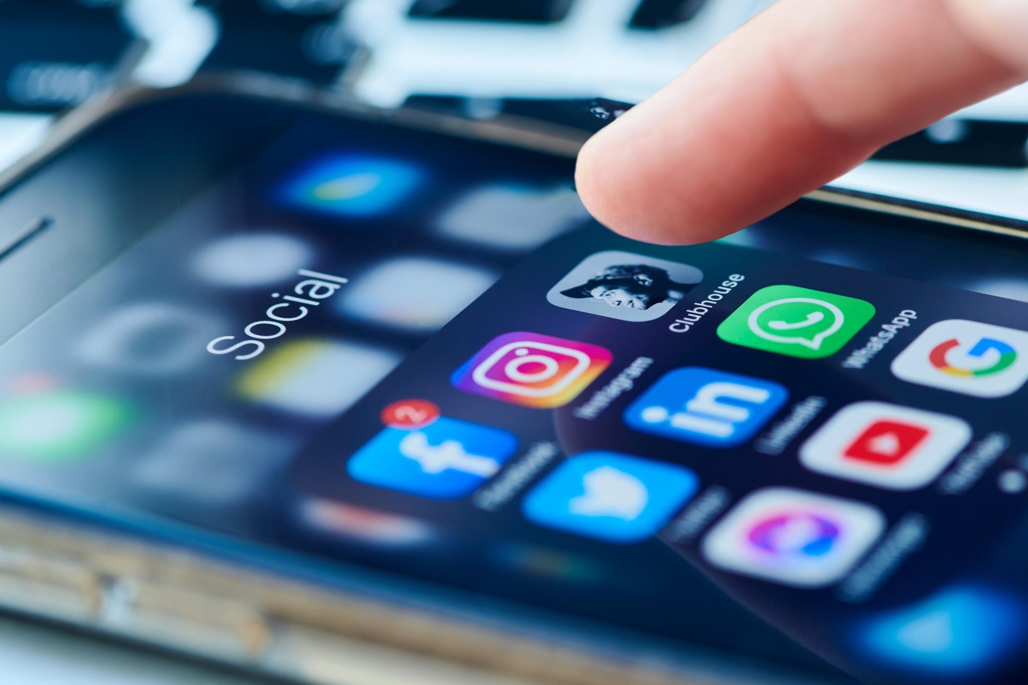 An iphone screen shows social media icons